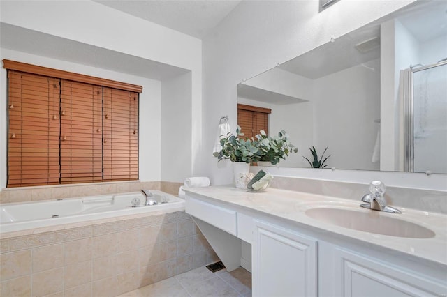 bathroom featuring a textured ceiling, vanity, independent shower and bath, and tile patterned flooring