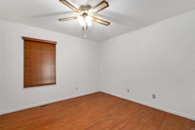 spare room with ceiling fan and wood-type flooring