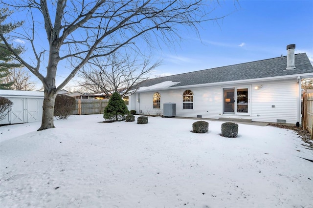 snow covered property with cooling unit