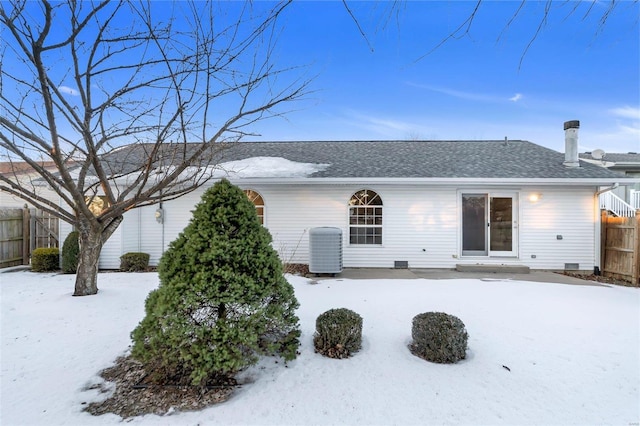 snow covered house with central AC unit