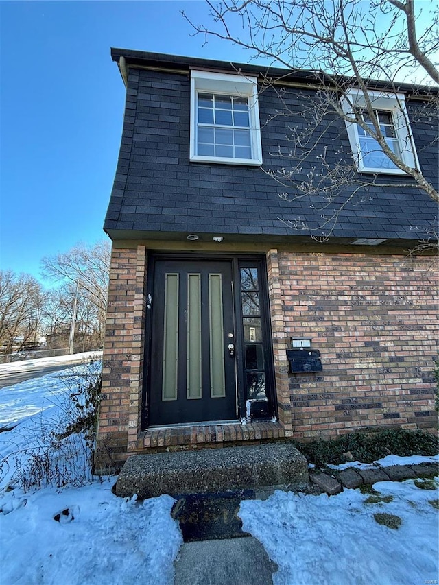 view of snow covered property entrance