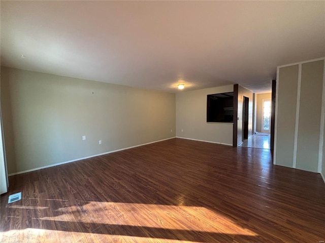 spare room with dark hardwood / wood-style floors