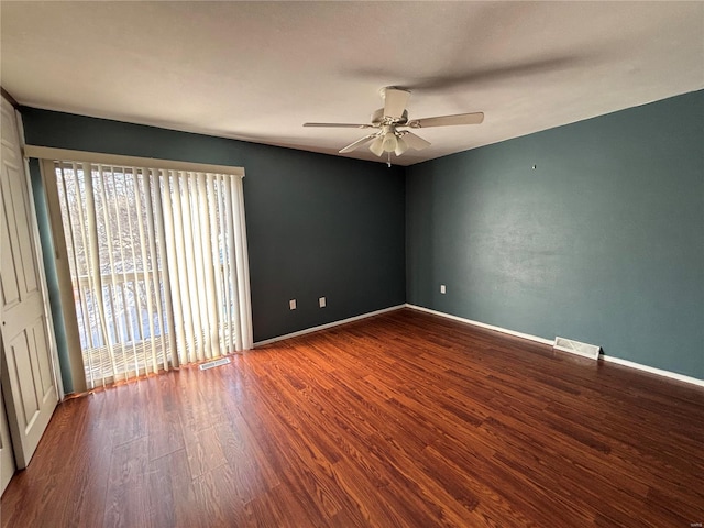 spare room featuring wood-type flooring and ceiling fan