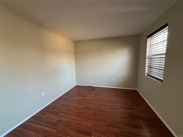 unfurnished room featuring dark wood-type flooring