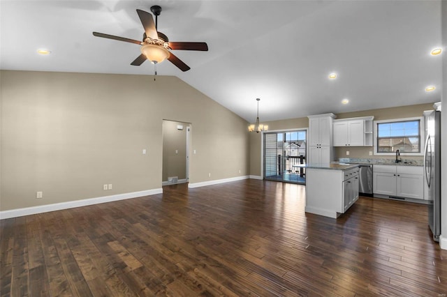 kitchen with white cabinetry, hanging light fixtures, stainless steel fridge, and plenty of natural light