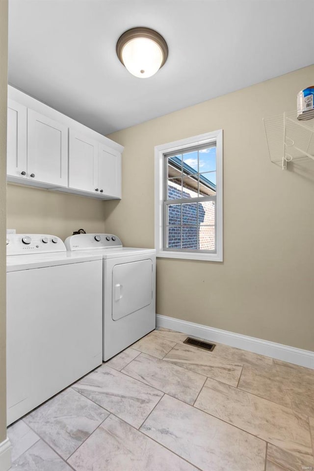 laundry room featuring cabinets and washing machine and clothes dryer