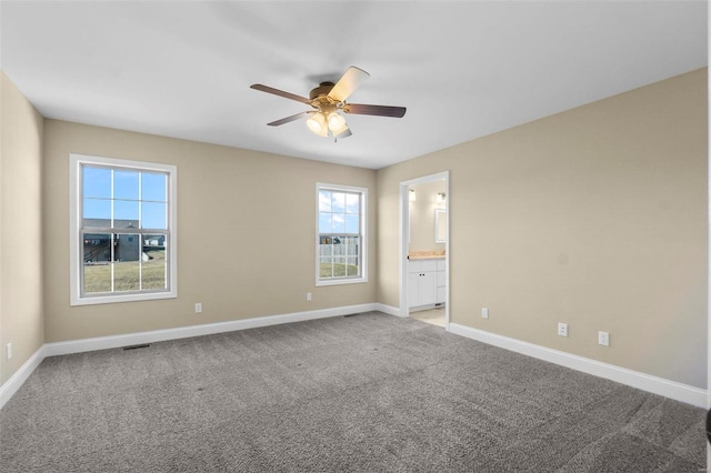 empty room featuring light carpet and ceiling fan