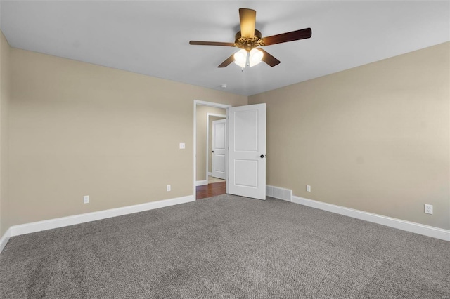 unfurnished bedroom with ceiling fan and dark carpet