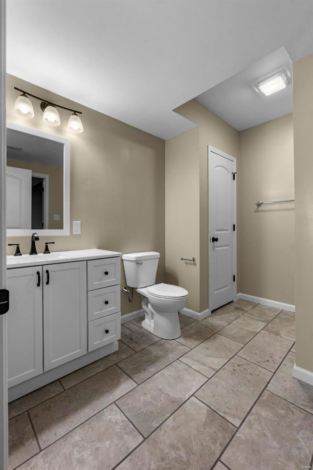 bathroom featuring vanity, tile patterned flooring, and toilet