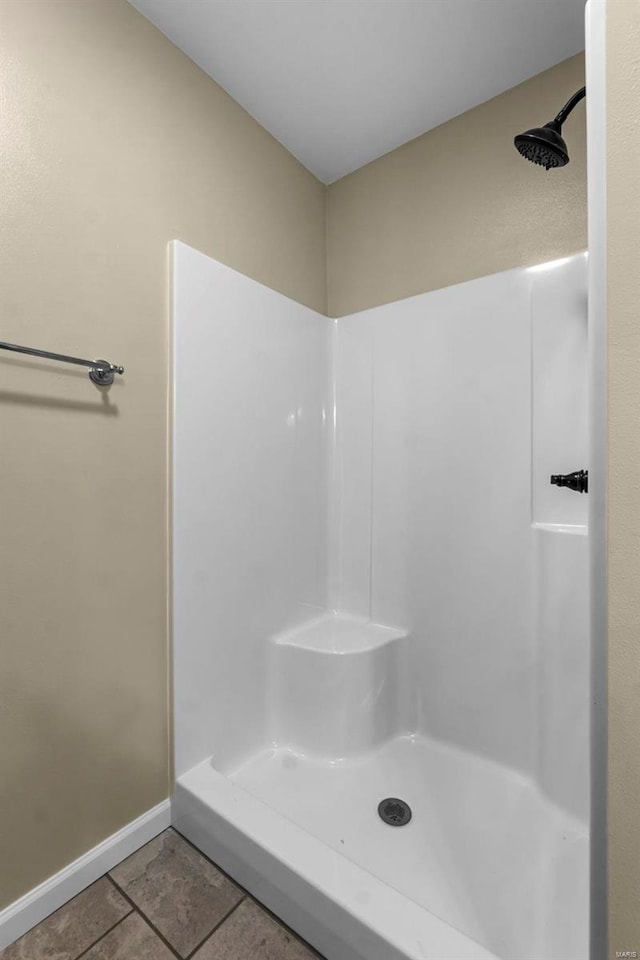 bathroom featuring tile patterned floors and a shower