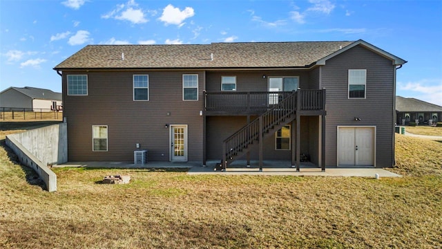 rear view of house with central air condition unit, a patio area, and a lawn