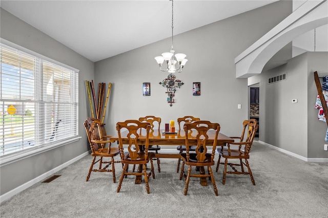 dining room featuring arched walkways, a chandelier, visible vents, baseboards, and carpet