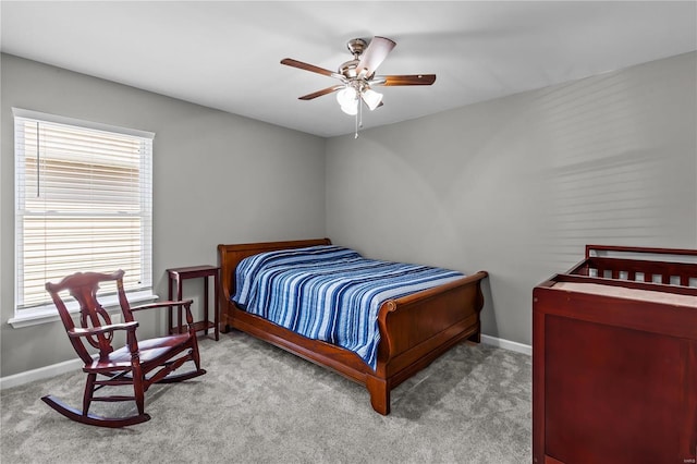 bedroom with ceiling fan, carpet, and baseboards