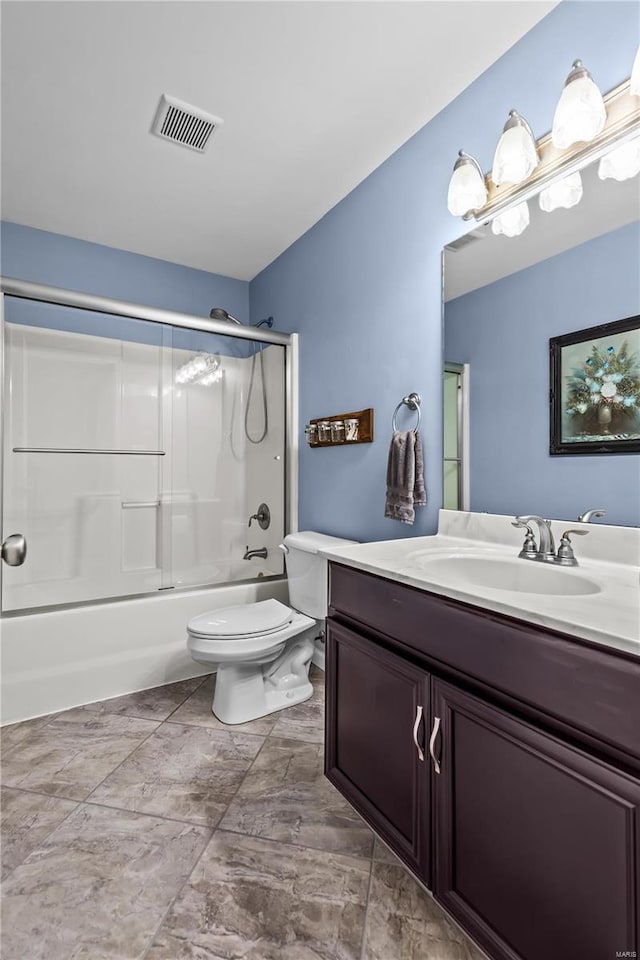 full bath featuring toilet, visible vents, combined bath / shower with glass door, and vanity