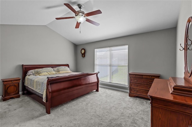 bedroom with vaulted ceiling, ceiling fan, and carpet flooring