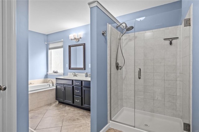 bathroom with a stall shower, a garden tub, vanity, and tile patterned floors