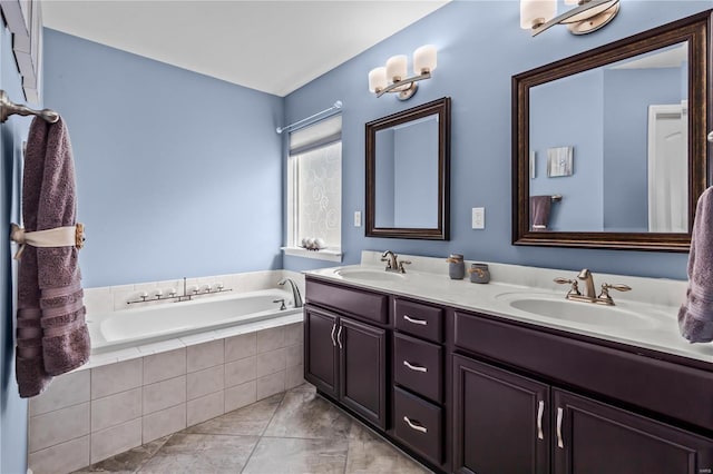 bathroom featuring double vanity, tile patterned flooring, a sink, and a bath