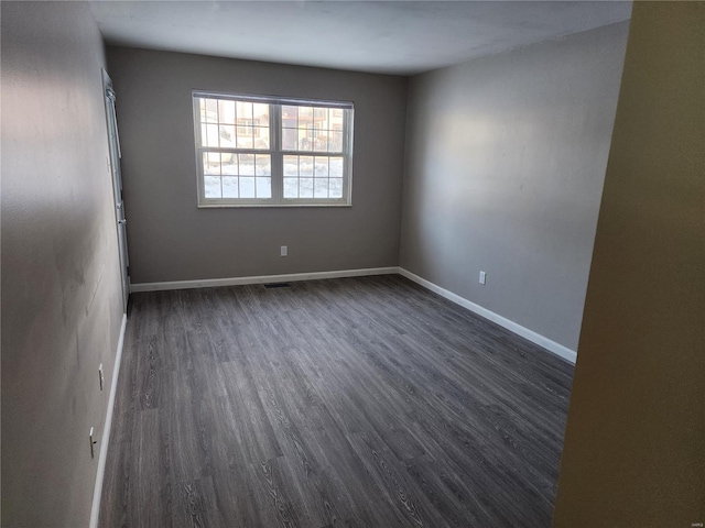 unfurnished room featuring dark wood-type flooring