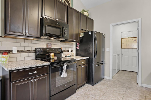 kitchen featuring backsplash, dark brown cabinetry, black appliances, light tile patterned flooring, and separate washer and dryer