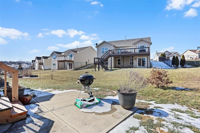 view of front of house featuring a deck, a patio area, and a front yard