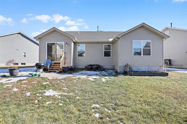 rear view of property with a yard and a patio area