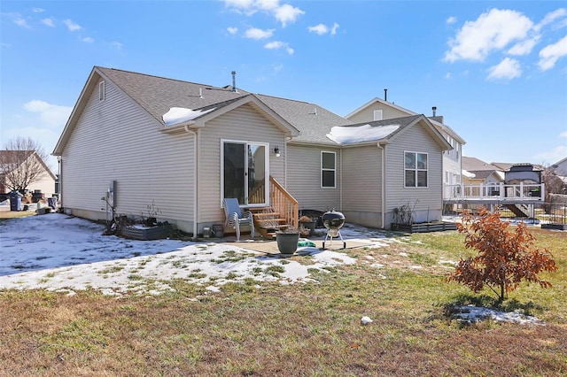 rear view of house with a patio area and a lawn