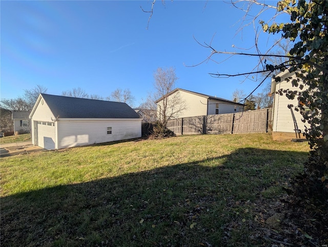 view of yard with a garage and an outdoor structure