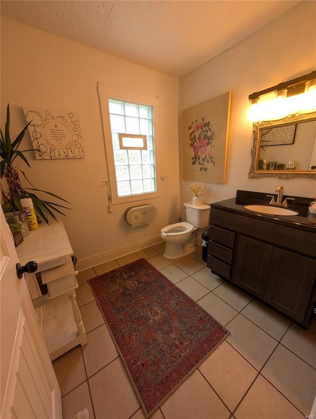 bathroom with tile patterned flooring, vanity, and toilet