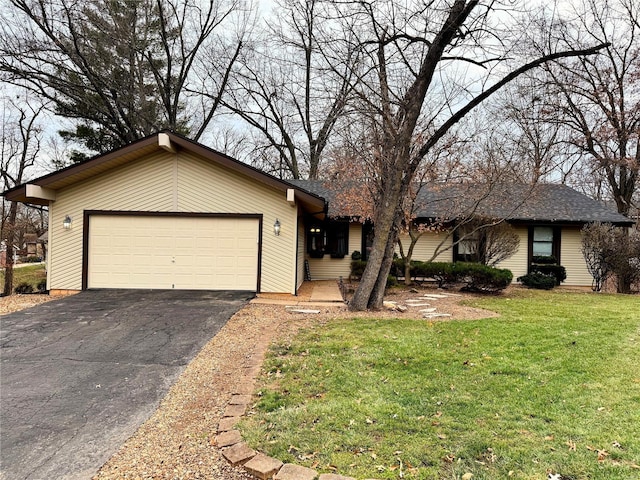 ranch-style house with a garage and a front lawn