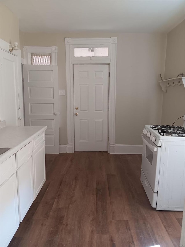 kitchen with white cabinetry, dark wood-type flooring, and white range with gas stovetop