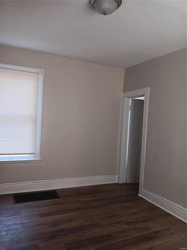 unfurnished room featuring dark hardwood / wood-style flooring