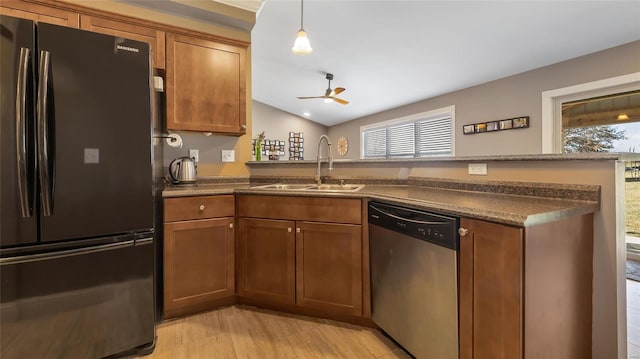 kitchen with sink, ceiling fan, black fridge, decorative light fixtures, and stainless steel dishwasher