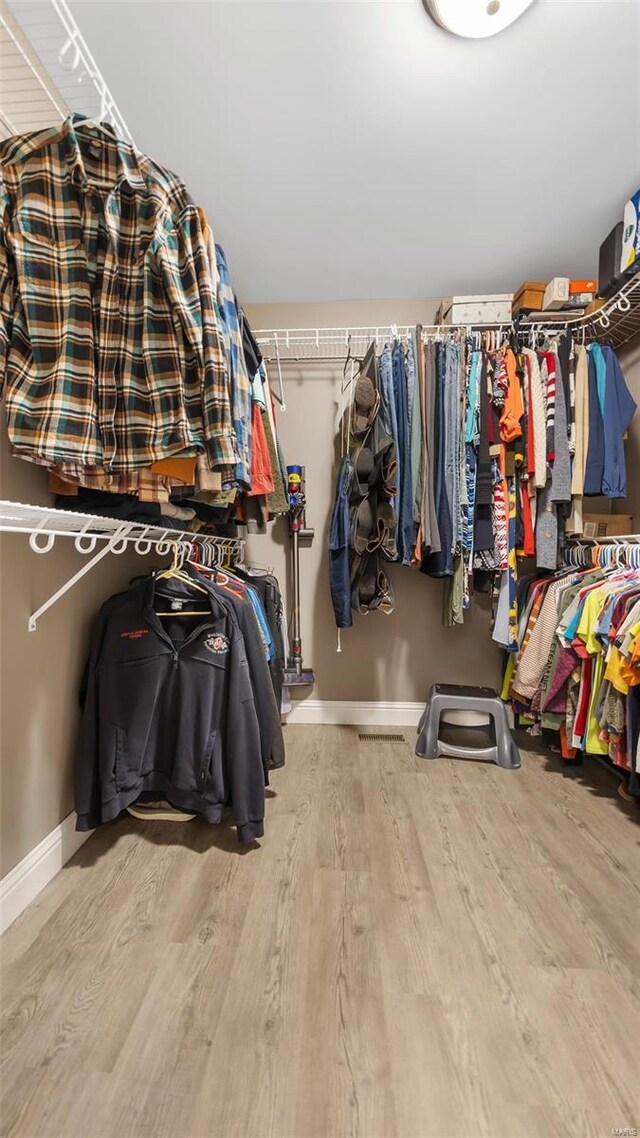 walk in closet featuring light hardwood / wood-style flooring