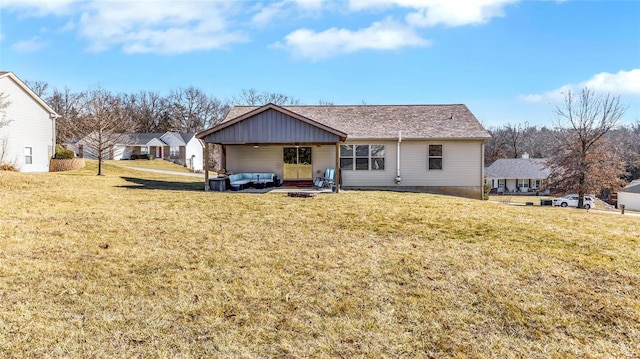 view of front of home with outdoor lounge area and a front lawn