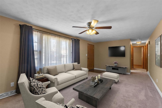 carpeted living room with ceiling fan