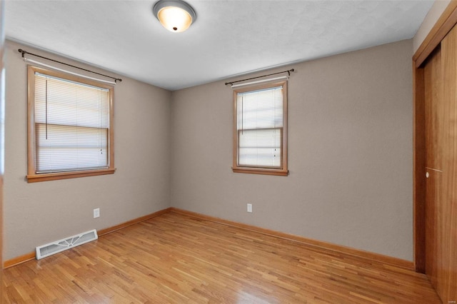 unfurnished room featuring light wood-type flooring