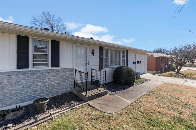 single story home with a front yard and a garage