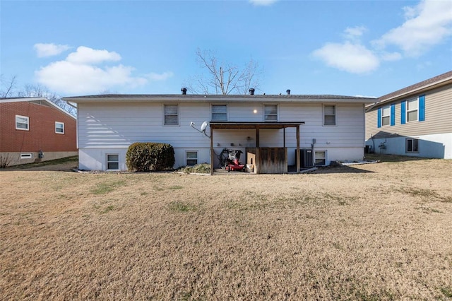 back of property with central AC and a yard