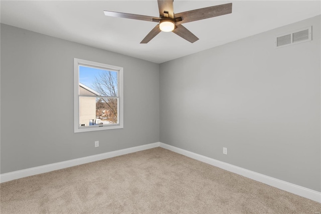 carpeted empty room featuring ceiling fan