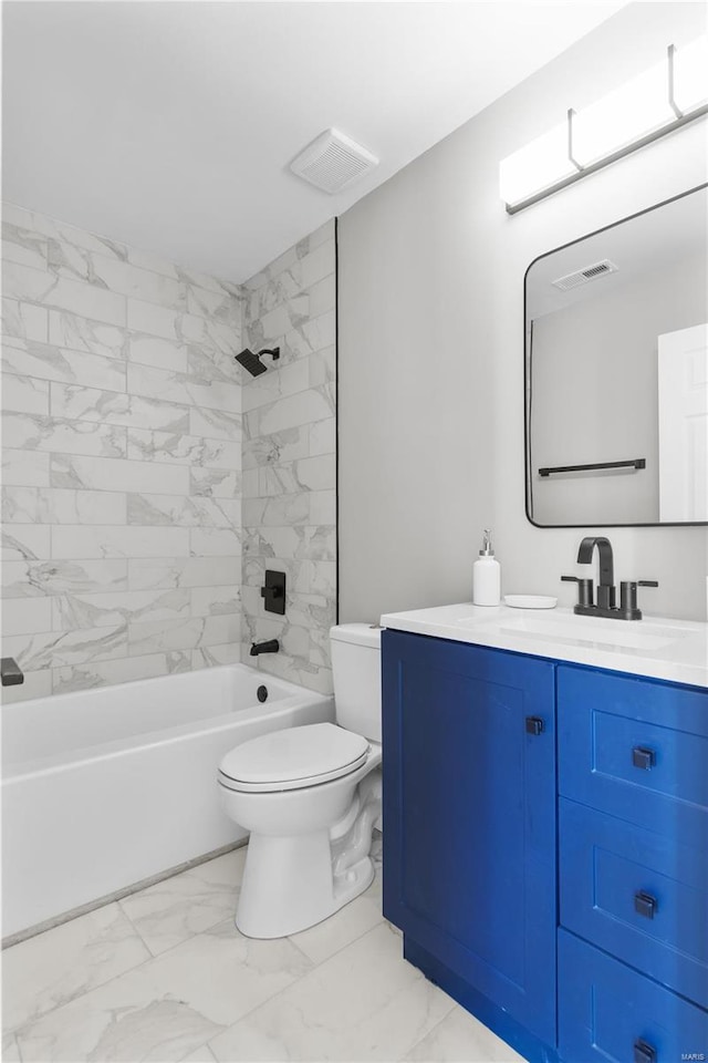 full bathroom featuring tiled shower / bath, vanity, and toilet