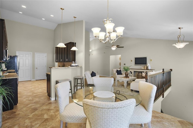 dining space featuring ceiling fan with notable chandelier and high vaulted ceiling