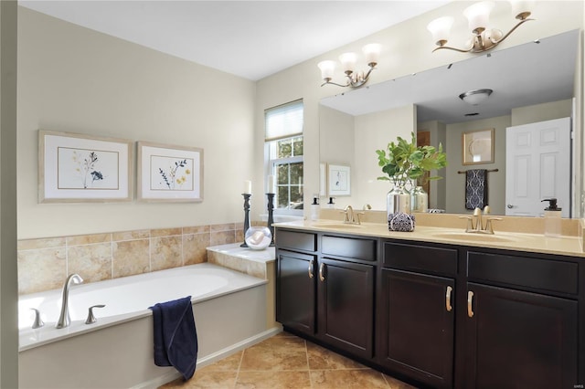 bathroom with vanity, a chandelier, tile patterned flooring, and a bathing tub