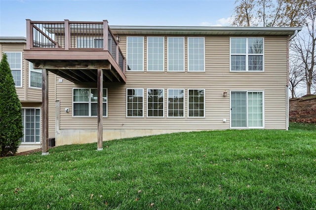 rear view of house featuring a yard