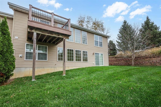 rear view of property featuring a lawn