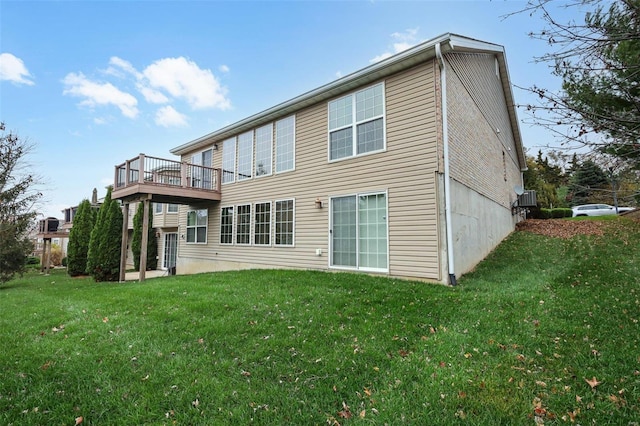 back of house with a deck and a yard