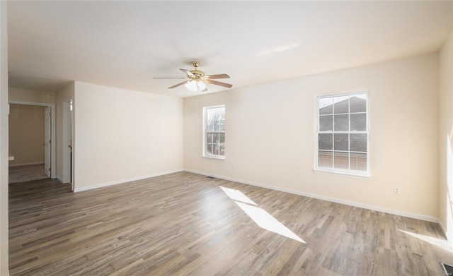 unfurnished room with ceiling fan and light hardwood / wood-style floors