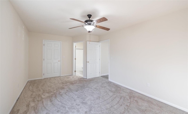 unfurnished bedroom featuring light carpet and ceiling fan