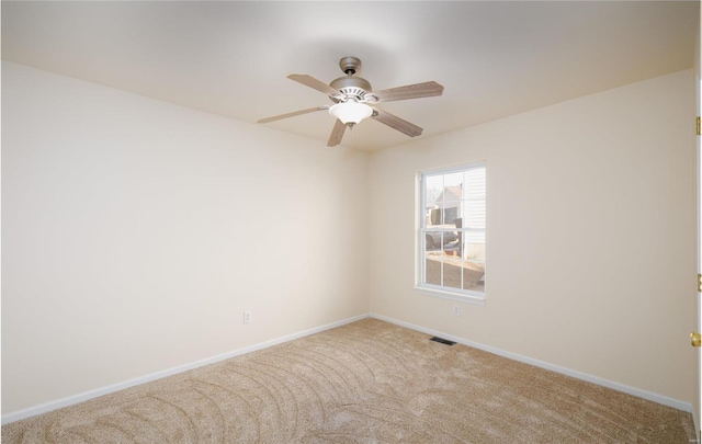 carpeted spare room with ceiling fan