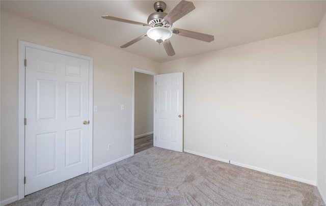 unfurnished bedroom featuring light colored carpet and ceiling fan