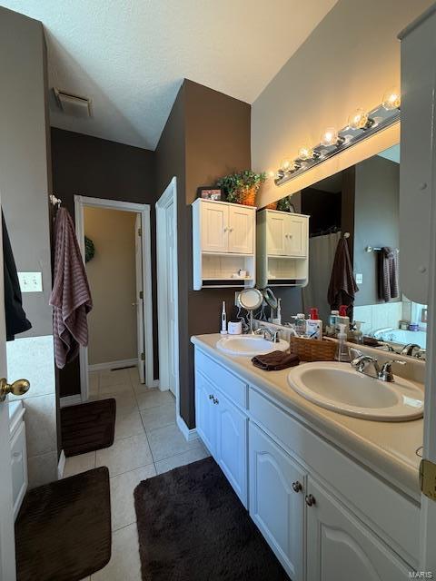 bathroom with tile patterned flooring and vanity